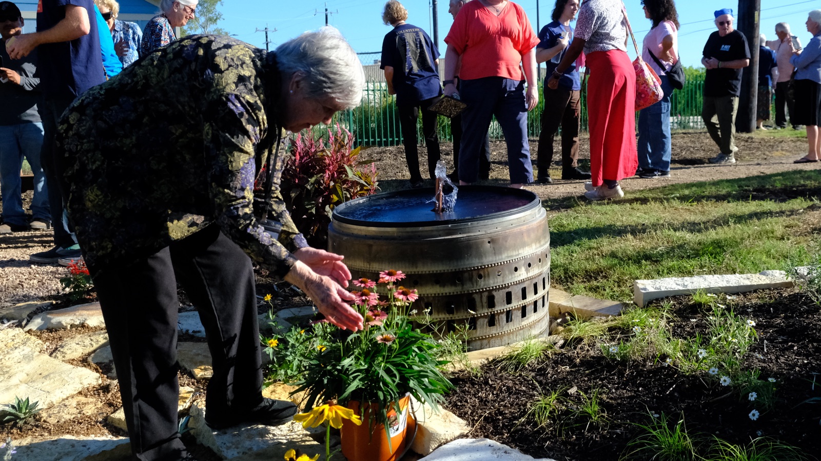 Residents and guests gathered at the fountains during the dedication at Towne Twin Village
